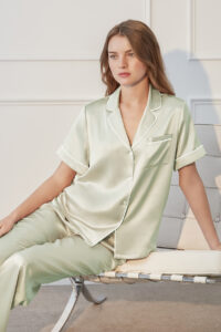 Model lounging in mint green MANITO Authentic Short Sleeve Pajama Set, highlighting luster and softness.