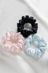 3 Pack Large Silk Scrunchie Set in black, pink, and sky blue, offering silky smooth comfort and versatile color pairing for daily styling.