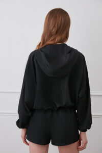 Back view of black Athflow women's sun protection hoodie set with hood.