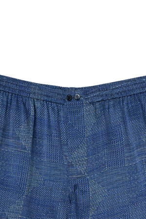 Detail of Cube Men's Shorts, showcasing elastic design and refined dot-line texture in navy silk.