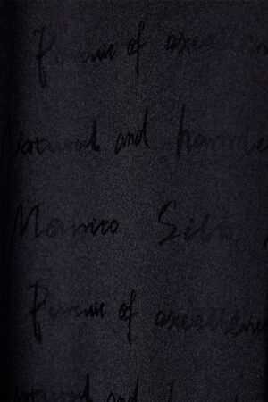 Close-up of the fine velvet detailing on Fiesta long black robe with feathers for holiday.