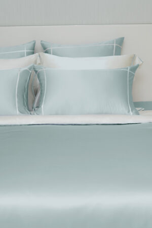 Detail of white trim on the MANITO Fluora Silk Bedding Set, highlighting exquisite stitching on silky fabric.