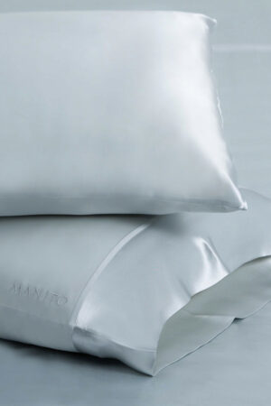 The 22 two-piece silk pillowcase set in elegant soft blue color.