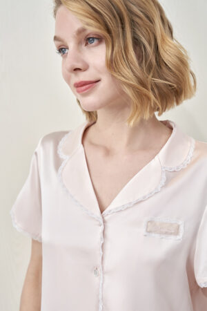 Close-up of MANITO Lunavie Women's Silk Short Sleeve Pajama Set collar and lace trim, soft pink silk with delicate detailing.