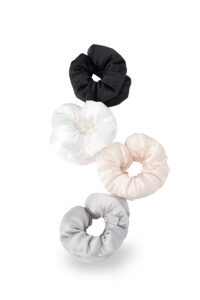 Four puff silk hair scrunchies in black, white, pink, and gray arranged on a white background.
