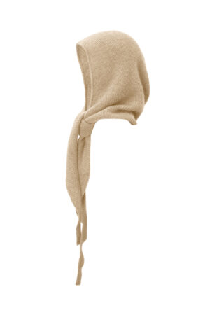 Purity Knit Balaclava in sand beige, side view showing the soft ribbed hood and long wrap ties for cozy everyday warmth.