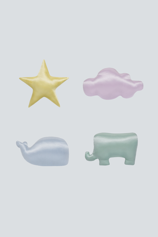 Assorted Kid's Silk Cushions in star, cloud, whale, and elephant shapes in pastel colors.