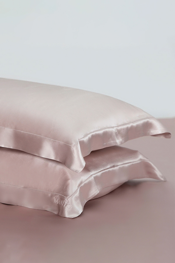 Two-piece 22 silk pillow sham set in soft pink, showcasing elegance and luxury for restful sleep.
