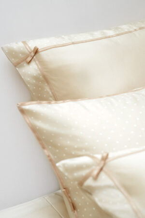 Close-up of MANITO ribbon silk pillowcase showcasing intricate ribbon ties and a smooth, silky texture for ultimate comfort.