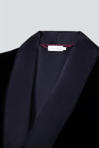 Close-up of MANITO velvet robe for men collar, showing satin lapel and inner label design.
