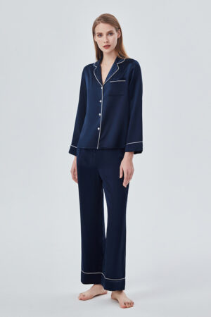 Woman showcased in navy blue Authentic Women's Silk Pajama Set, featuring classic design with modern elegance.
