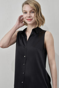 Model wearing MANITO Signature Women's Silk Sleeveless Shirt with button-up front and pointed collar.