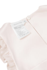 Back neck label and button detail of MANITO Sophia Baby Sleeveless Romper.