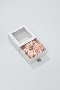 Pink Thick Silk Scrunchie nestled in a drawer box, tidy for storage and gifting.