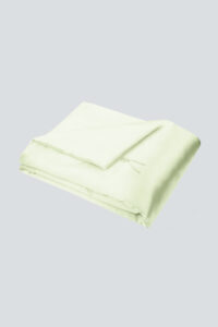 Light green Silk Throw Blanket folded neatly with tie detail visible.